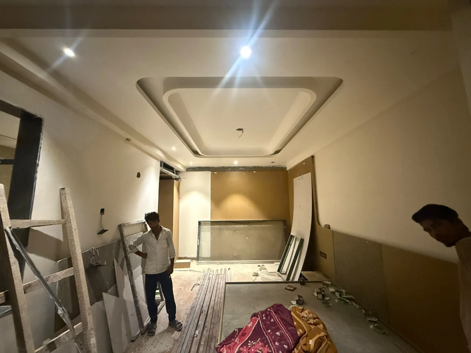 Hotel room under construction with ceiling and wall work underway